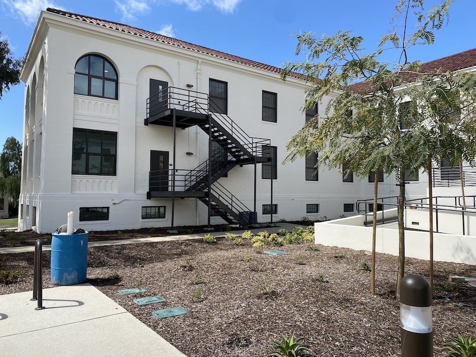 View of south wing of rehabilitated Building 205, showing newly pained exterior, new windows and landscaping 